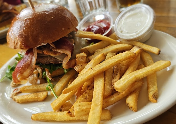 Benchmark Eatery signature dishes Classic Double CheeseburgerBlackened Chicken WrapB.L.A.T. Sandwich